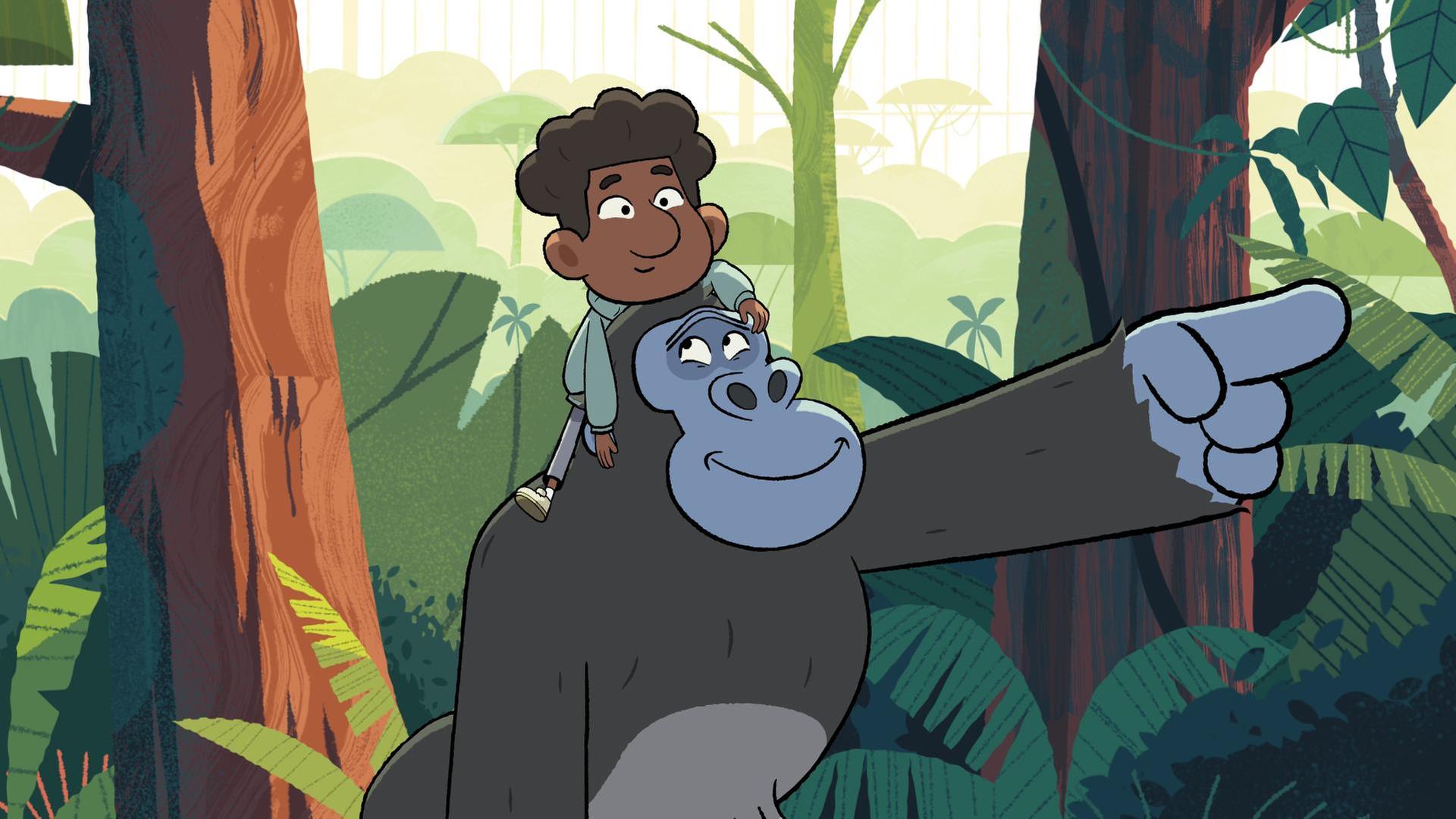 Gorilla Jack trägt Tommy auf den Schultern und zeigt freundlich lächelnd nach vorne.