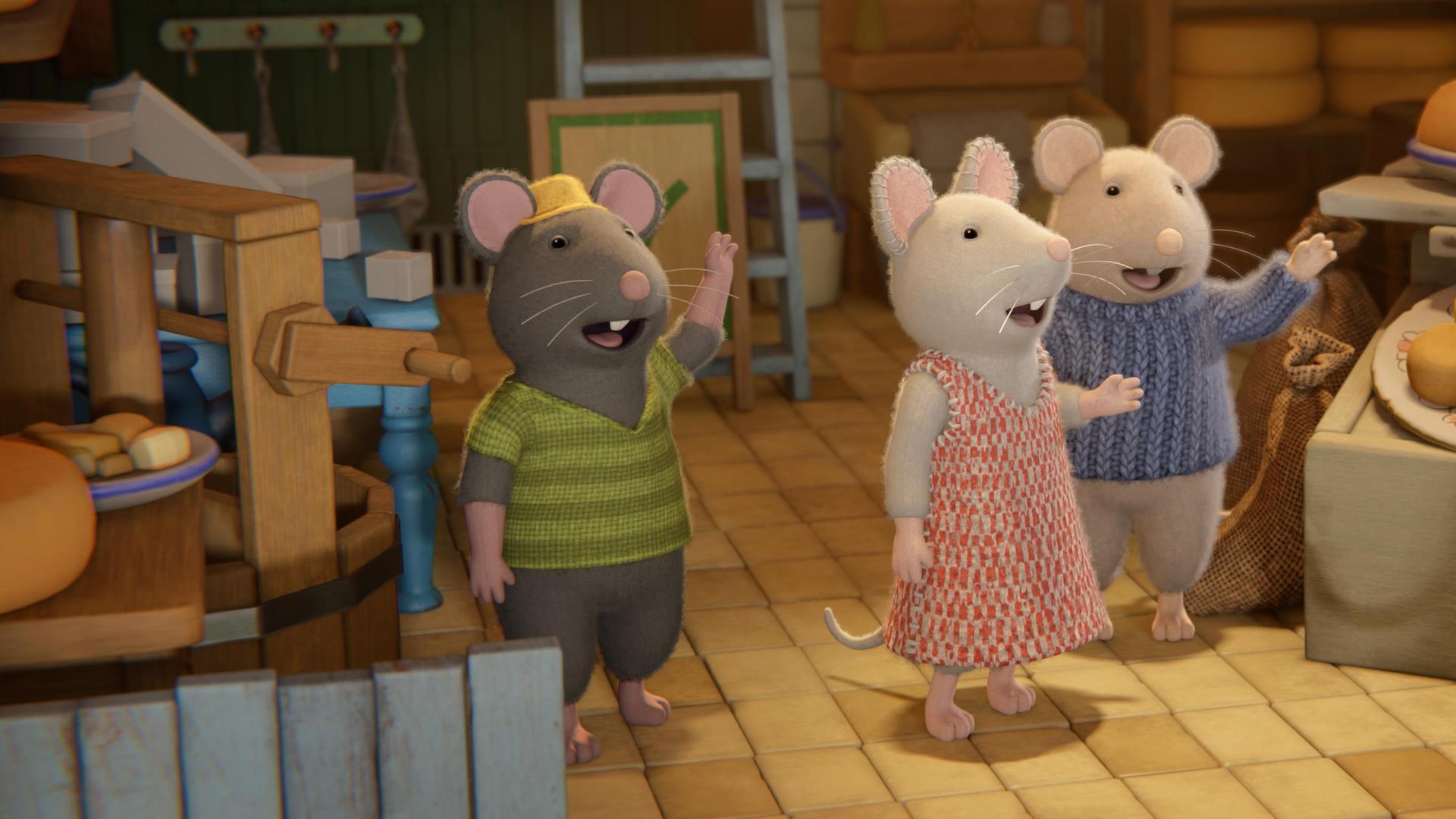 Mitten in einem Käseladen stehen Tonio, Julia und Sam und winken dem Vater von Tonio hinterher, der gerade den Laden verlässt. Um sie herum stehen mehrere Verkaufsstände mit Käsestücken. Auf einer Verkaufstheke stehen Teller mit Käse. Eine große Waage und Regale sind im Hintergrund des Ladens.