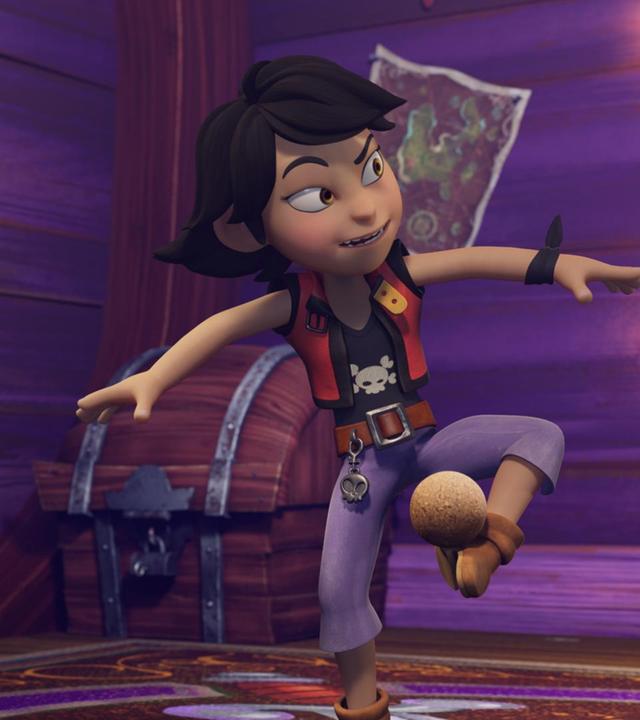 Zoe tanzt fröhlich in ihrem Schlafraum. Auf dem linken Fuß balanciert sie eine Kokosnuss. Seitlich an der Wand steht ein Skelett mit Piratenhut.