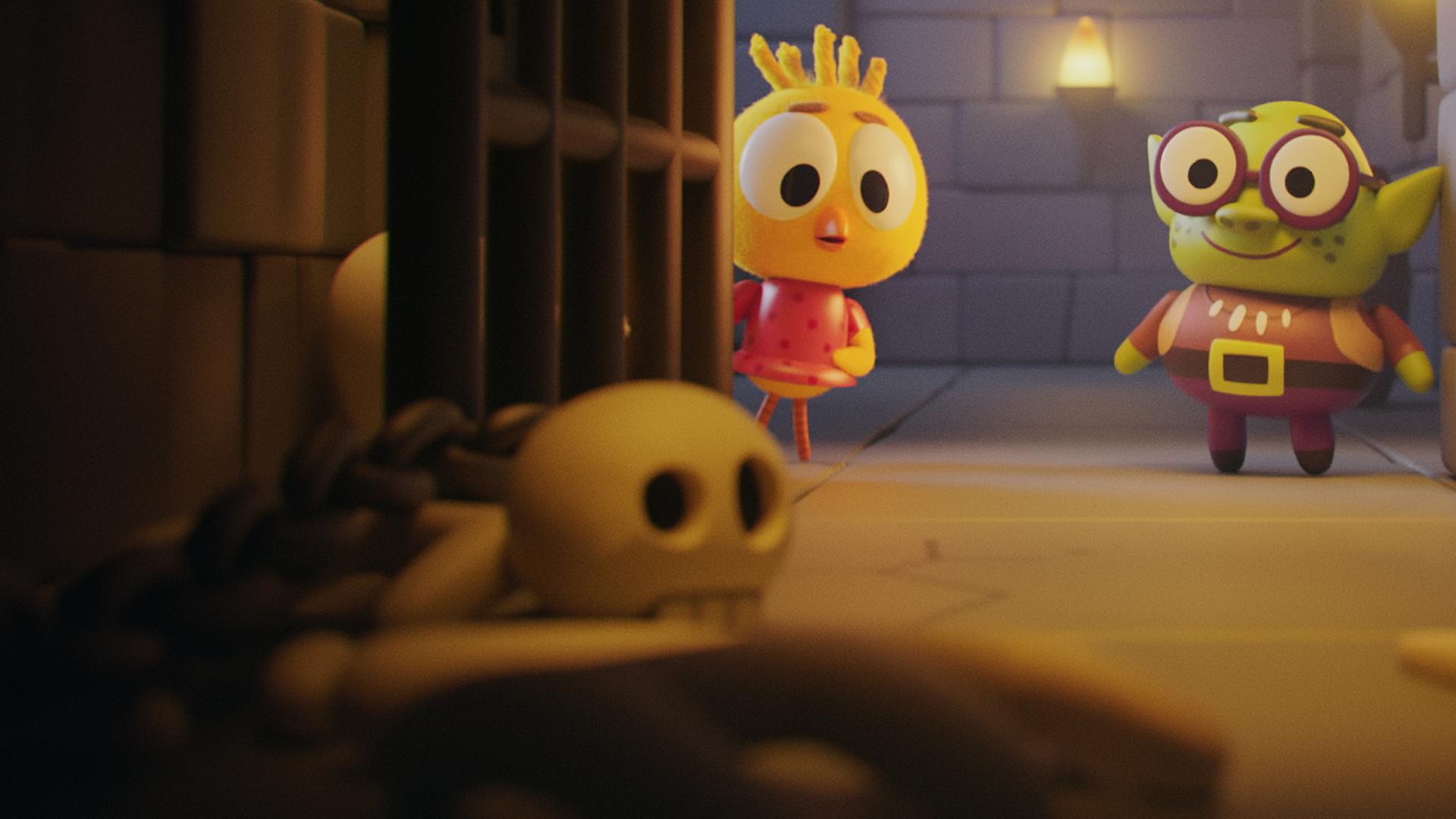 Das Küken Karla und Troll Oggi stehen vor einer offenen Kerkerzelle. Die schwere Gittertür der Zelle steht weit offen. Im Inneren ist es dunkel und auf dem Boden liegen zwei Totenköpfe. Der Hintergrund besteht aus dunklen, groben Steinmauern. Beide blicken in Richtung der Kerkerzelle.