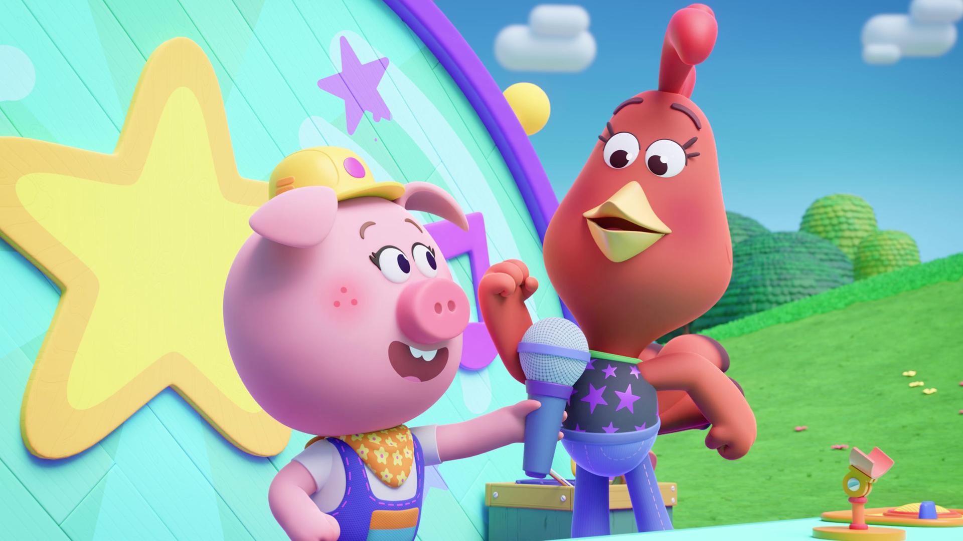Wir sehen ein Schweinchen mit Bauarbeiter-Helm und Cherry, ein Huhn, vor einem Pult stehen. Im Hintergrund ist eine Art Bühne. Das Schweinchen Cornelia hält Cherry ein Mikrofon vor den Schnabel.