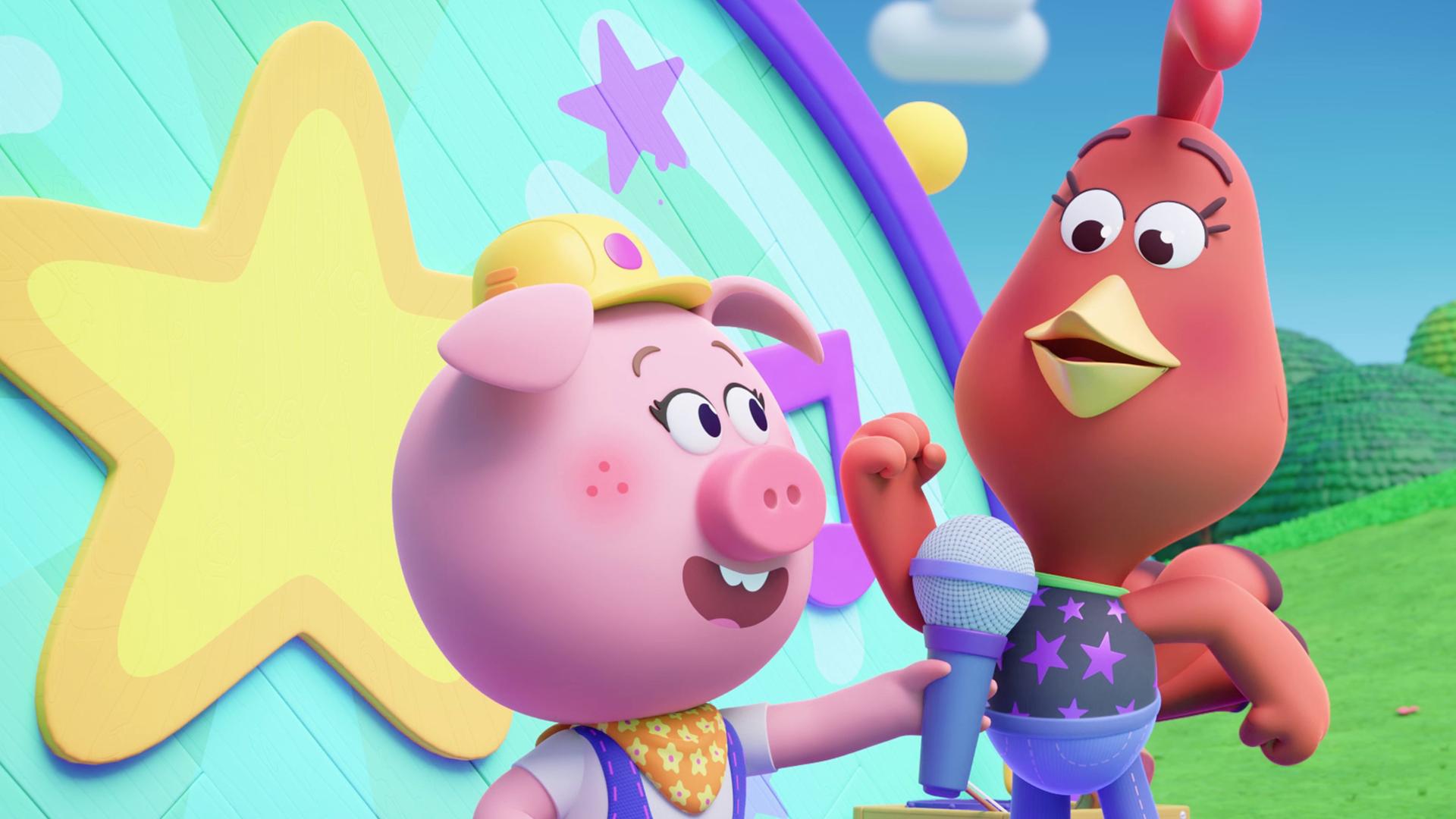 Wir sehen ein Schweinchen mit Bauarbeiter-Helm und Cherry, ein Huhn, vor einem Pult stehen. Im Hintergrund ist eine Art Bühne. Das Schweinchen Cornelia hält Cherry ein Mikrofon vor den Schnabel.