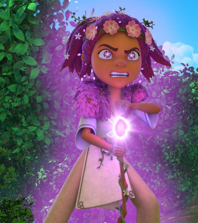  Druidin Katell steht im Wald. Sie sehr zornig nach vorne und hält ihren Druidenstab in der Hand. Der Smaragd ihres Stabs leuchtet lila auf. Auch ihre Augen blitzen lila vor Zorn. Um sie und ihre Gestalt glüht ein lilafarbenes Leuchten.