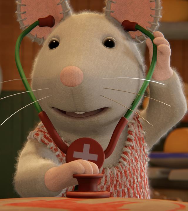 Julia hat ein Stethoskop in den Ohren, um ihre Patienten damit abzuhören. Sie freut sich darauf, Arztpraxis zu spielen.