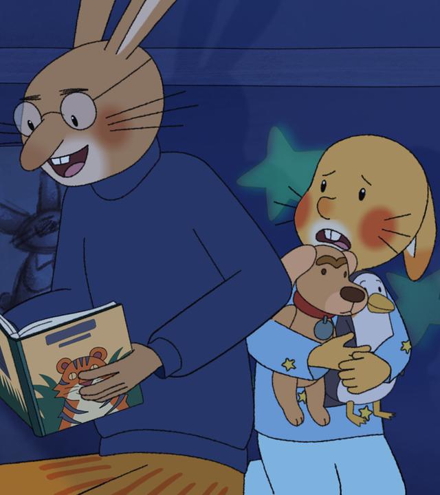 In einem dunklen Zimmer liest Papa seinem Sohn Karlchen eine "Gute-Nacht-Geschichte" vor. Papa hält ein Buch, auf dem ein Tiger abgebildet ist, in der Hand. Neben ihm sitzt Karlchen, der sich erschrocken an seine Kuscheltiere klammert. 