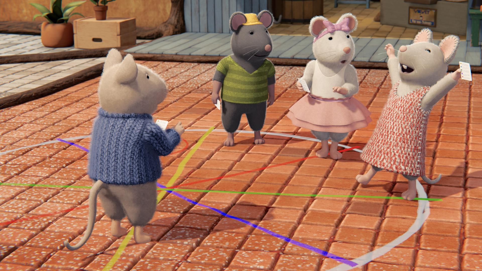 Im Hof des Mäusehauses ist ein weißer Kreis mit bunten Trennlinien darin auf den gepflasterten Boden gemalt. Im Kreis stehen in verschiedenen Feldern Sam, Tonio, Ella und Julia. Julia hat ihre Arme freudig jubelnd in die Höhe gestreckt. Sie hält wie die anderen Mäusekinder einen weißen Zettel in der Hand. Sam, Tonio und Ella schauen aufmerksam zu Julia.