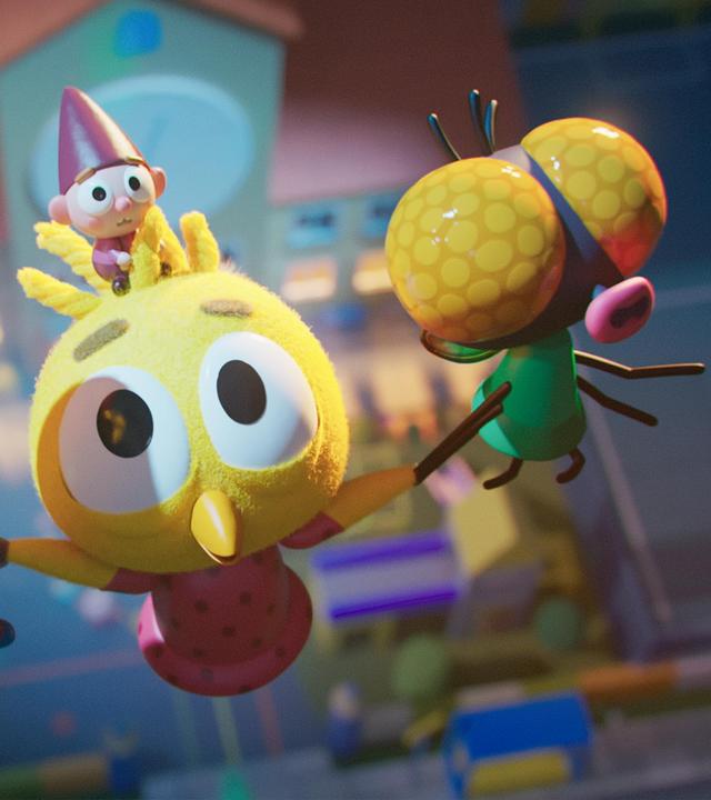 Das Küken Karla fliegt aufwärts, unterstützt durch ihre fliegenden Freunde Fledermaus Vampi und Fliege Brumm, die sie an ihren Flügeln festhalten. Auf Karlas Kopf sitzt Wichtel Bob, der verängstigt blickt. Unter ihnen befindet sich die Schule.