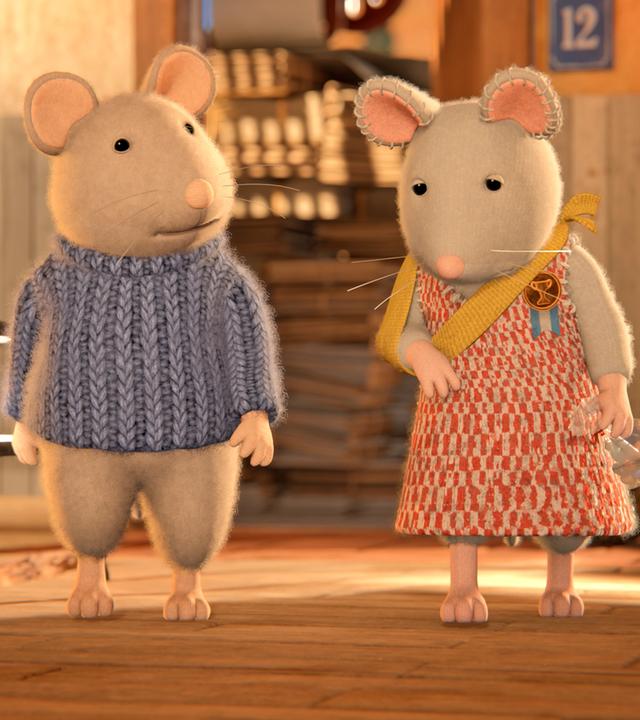 Sam und Julia laufen durchs Treppenhaus an einem Geländer vorbei. Julia hat ihren rechten Arm in einer Schlinge, in der linken Hand hält sie eine Bonbontüte. Julia schaut schuldbewusst zu Boden, während Sam sie erstaunt ansieht.