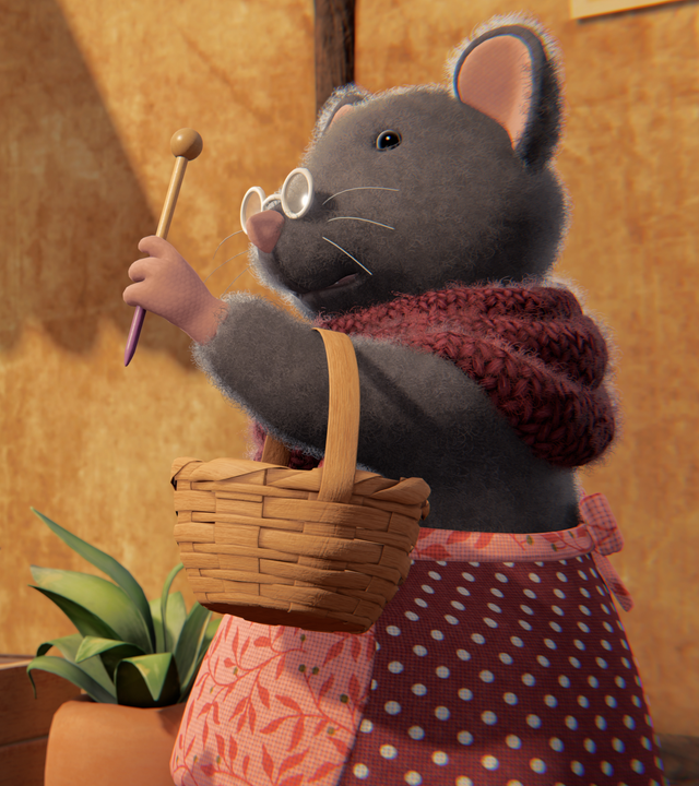 Julia steht Oma Gouda gegenüber, die einen Korb in der Armbeuge hat und diesen Arm hochhält mit einer Stricknadel in der Hand.