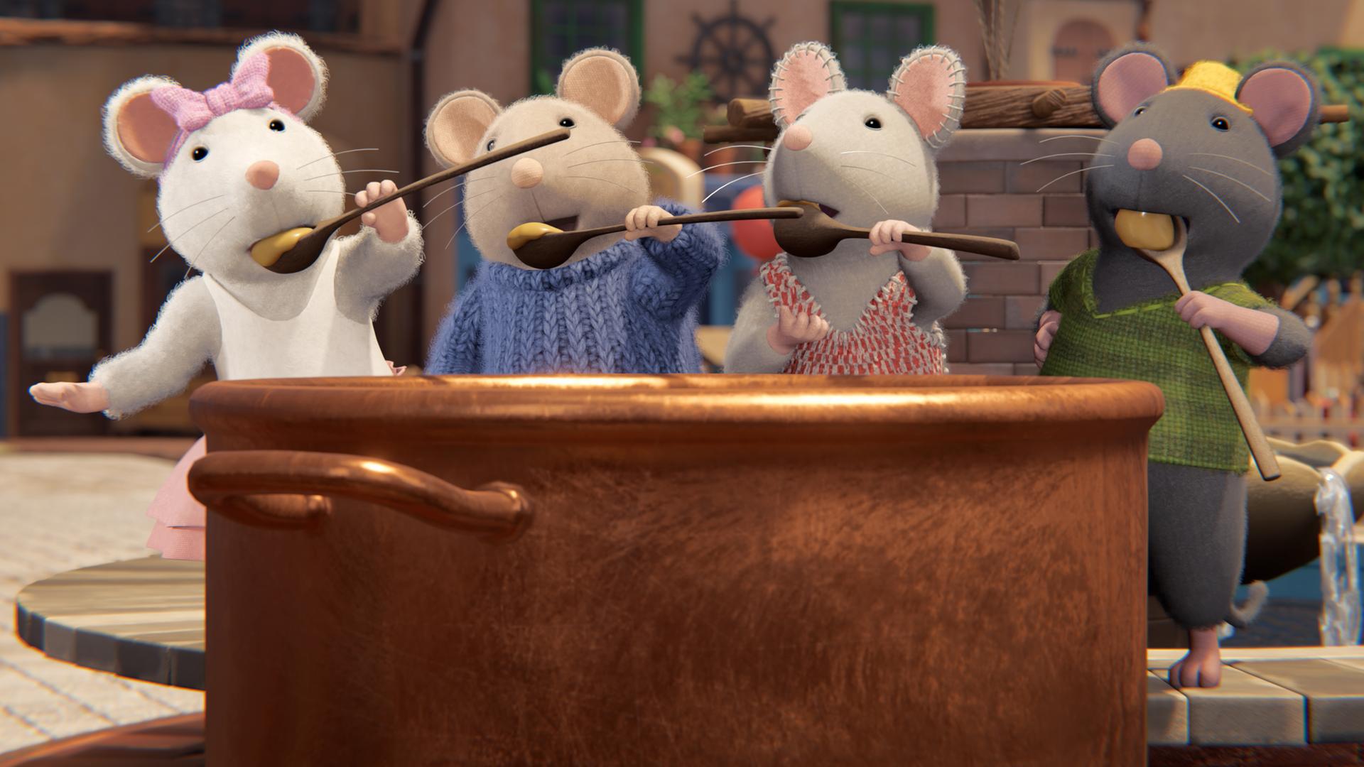 Ella, Sam, Julia und Tonio stehen hinter einem riesigen, braunen Ton-Topf mit flüssigem Käse. Alle haben Käse auf ihren Holzlöffeln und probieren ihn gerade.