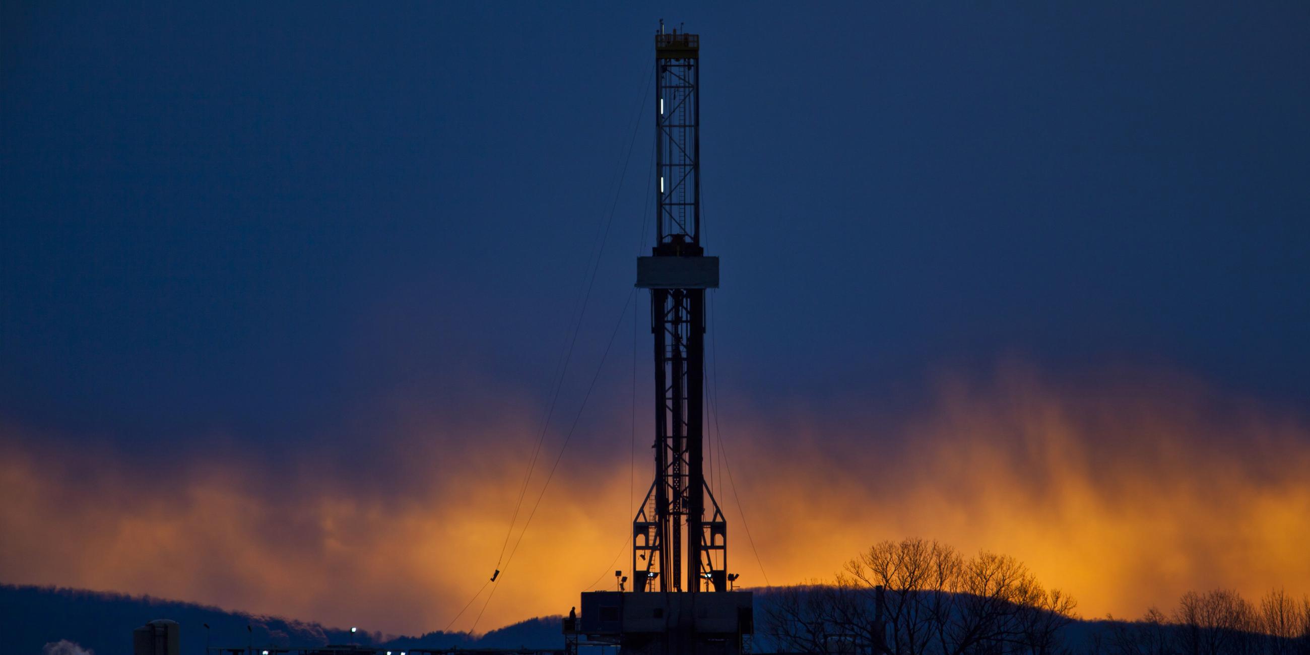  Der Bohrturm einer Ölförderplattform, die nach dem Prinzip des "Fracking" arbeitet ist als Sillhouette zu sehen. 