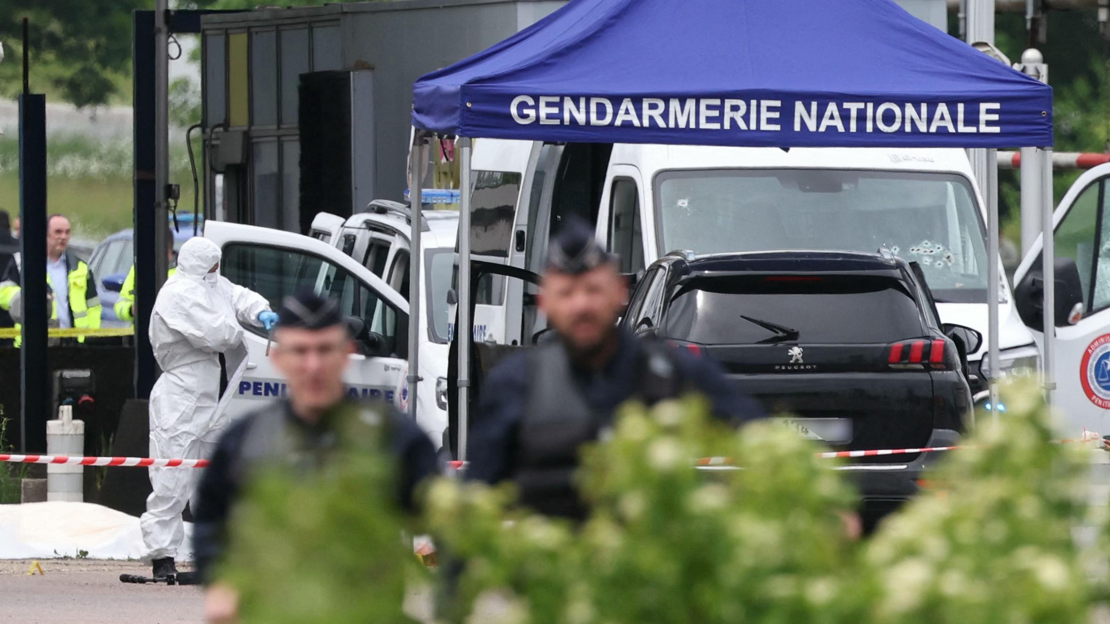  Ein Gerichtsmediziner arbeitet, während Polizisten am Ort eines Rammangriffs patrouillieren, der sich am späten Vormittag an einer Mautstelle in Incarville in der nordfranzösischen Region Eure ereignete. 