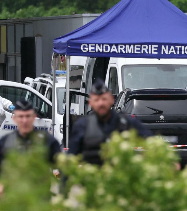  Ein Gerichtsmediziner arbeitet, während Polizisten am Ort eines Rammangriffs patrouillieren, der sich am späten Vormittag an einer Mautstelle in Incarville in der nordfranzösischen Region Eure ereignete. 