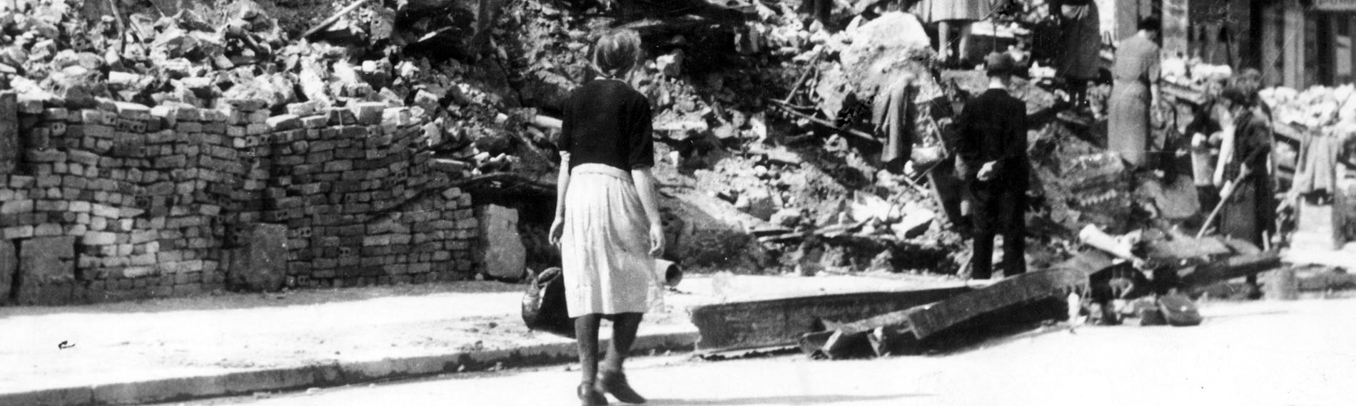 Frauen arbeiten an vom Krieg zertörten Häusern