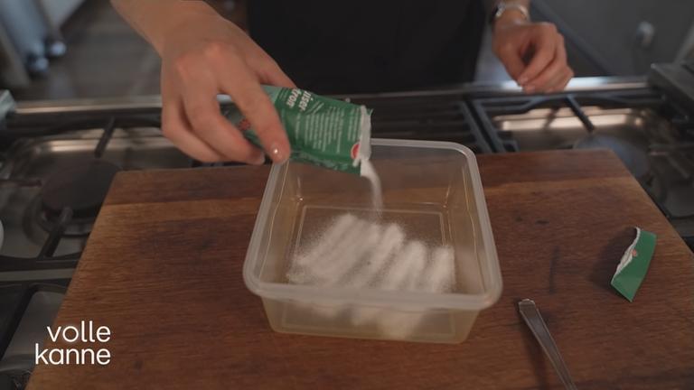 Frischhaltedosen richtig reinigen: In eine Box wird Natronpulver gefüllt.