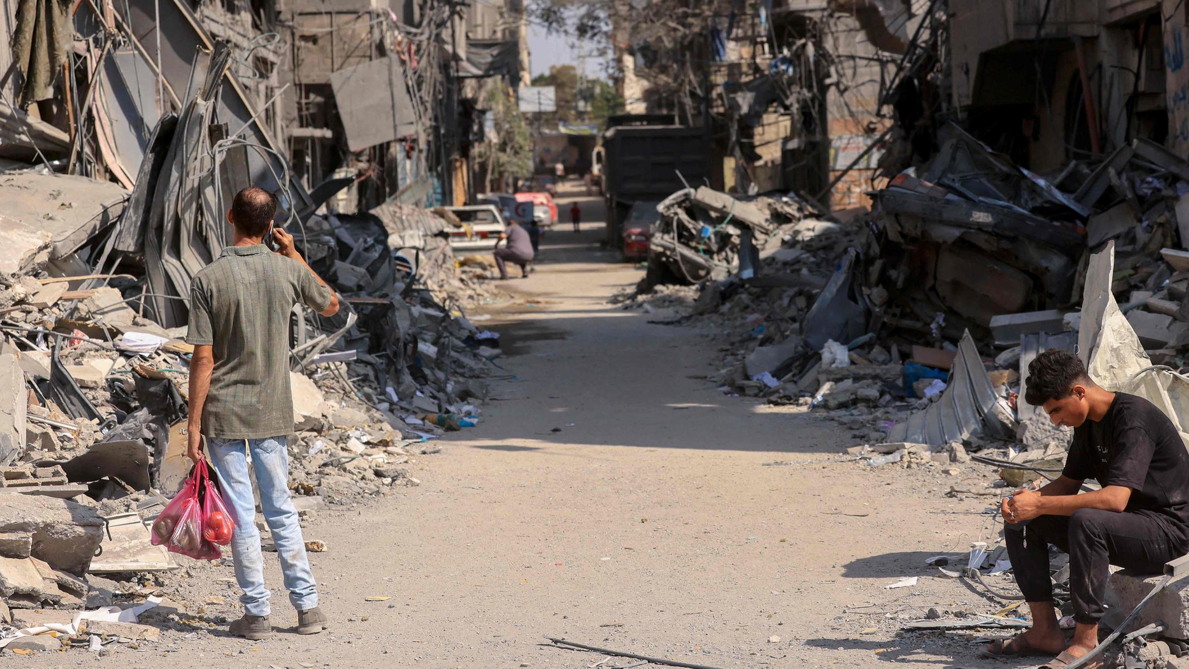 Palästinenser begutachten die Schäden,  am 24.10.2023 in Khan Yunis im südlichen Gazastreifen.