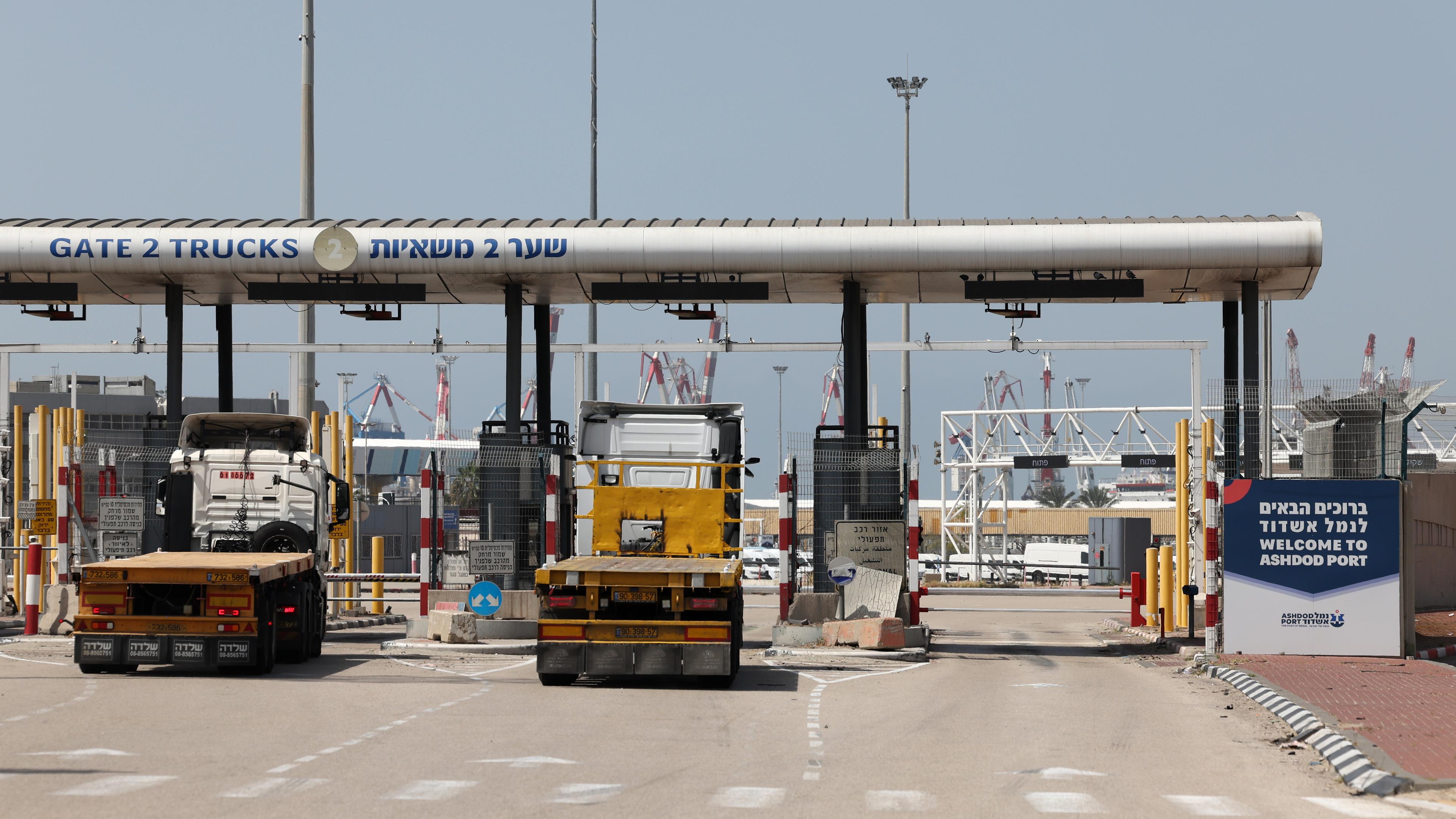 Lastwagen fahren durch ein Tor am Eingang des Hafens von Aschdod