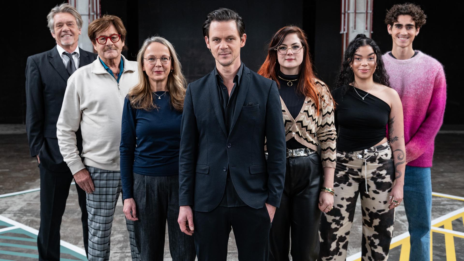 Moderator Jo Schück steht mit seinen sechs Gästen auf dem 13 Fragen-Spielfeld.