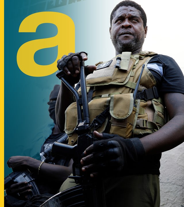 Mann mit Schutzweste und Waffe auf Haiti