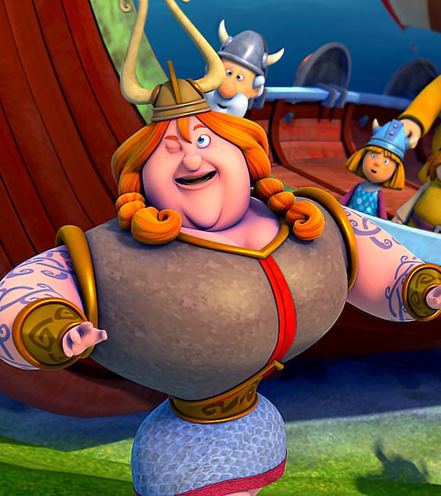 Halvar steht mit der Königin vor dem Schiff der Wikinger. Auf dem Schiff stehen die Männer von Halvar, die überrascht aussehen.