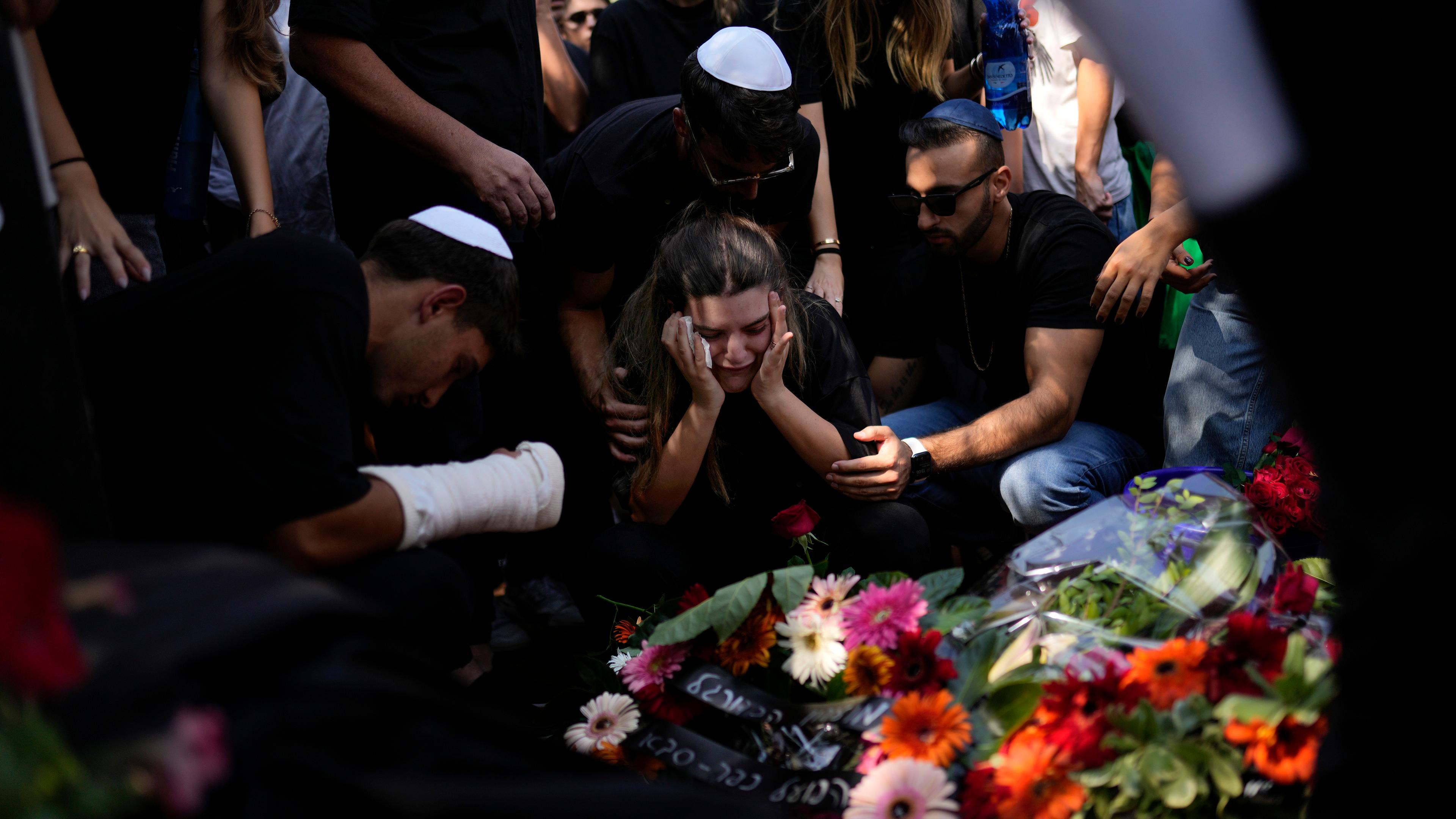 Mourners gather around the grave of May Naim, 24, during her funeral in Gan Haim, central Israel, Wednesday, Oct. 11, 2023.