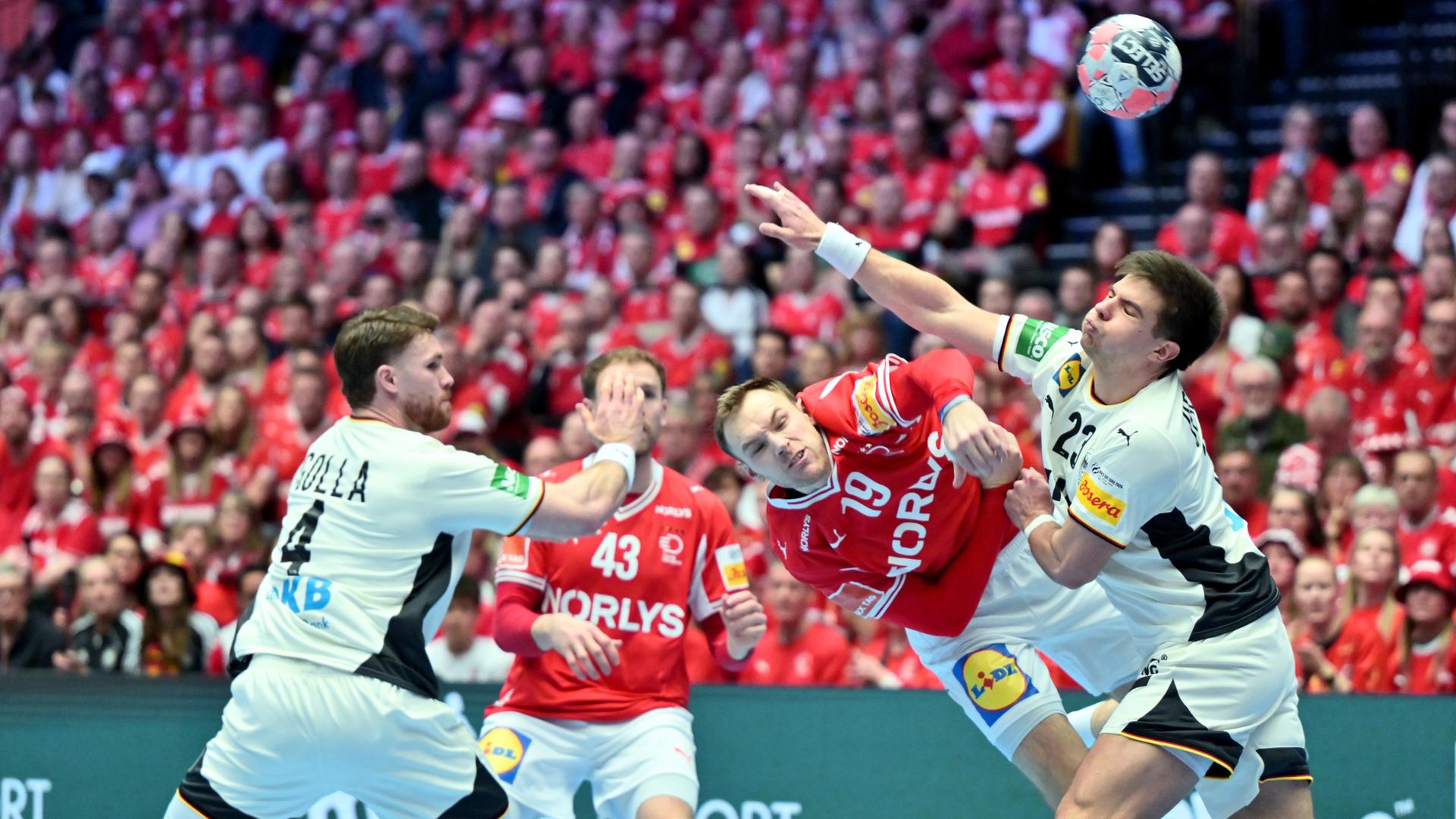 Dänemarks Mathias Gidsel setzt sich im Duell gegen Deutschlands Renars Uscins (r) durch.