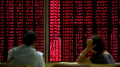 Chinesische Investoren beobachten die Aktienkurse in einem Brokerhaus.