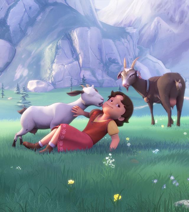 Heidi spielt auf einer Wiese mit Ziegen. Dabei schleckt ihr eine Ziege das Gesicht ab.