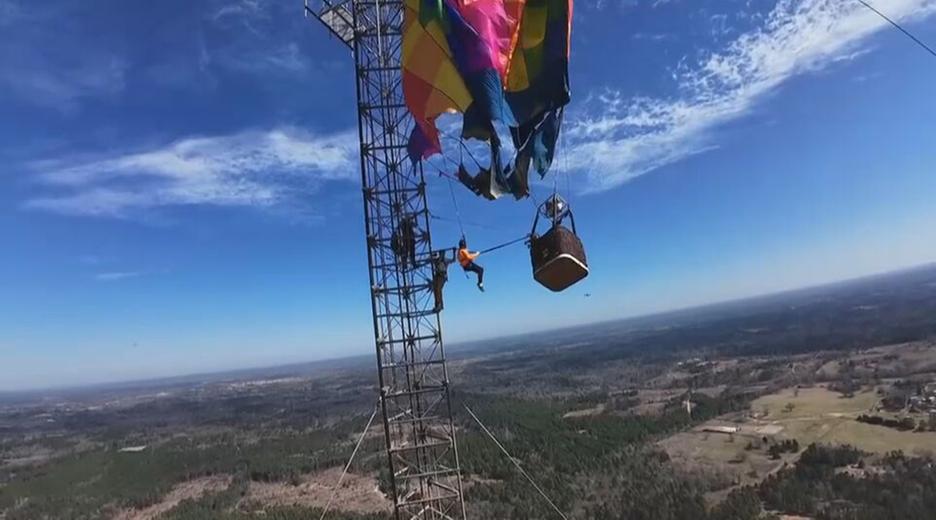 Ein Heißluftballon hängt an einem Funkmast fest. 