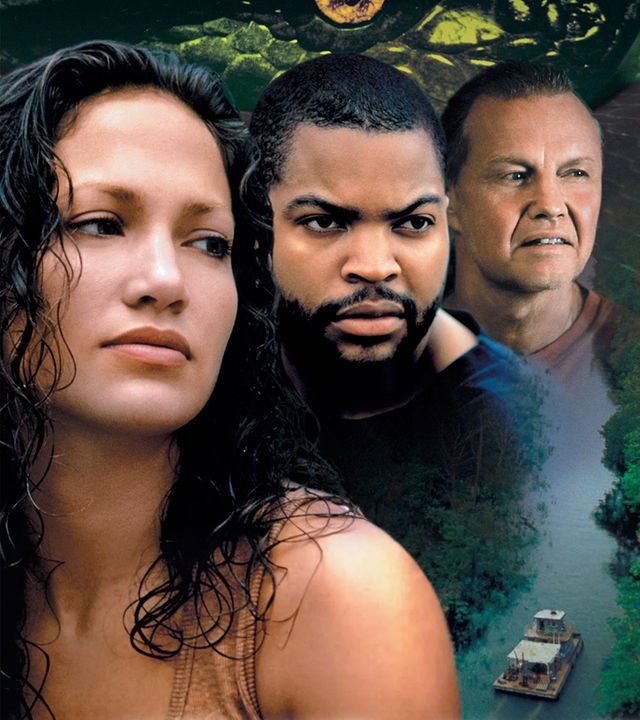 Das Filmplakat zu „Anaconda“ zeigt im Vordergrund die drei Hauptcharaktere Terri Flores (Jennifer Lopez), Danny Rich (Ice Cube) und Paul Serone (Jon Voight) vor einer dichten, grünen Dschungellandschaft mit einem kleinen Boot auf einem Fluss. Über den Köpfen der Schauspieler ist die riesige, gelb-grüne Haut einer Schlange zu sehen, die bedrohlich über der Szenerie liegt.