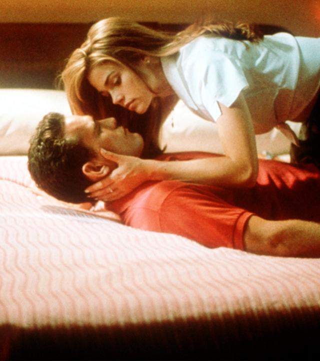 Sam Lombardo (Matt Dillon) und Kelly Lanier Van Ryan (Denise Richards) liegen aufeinander auf einem Bett und schauen sich verliebt gegenseitig an.
