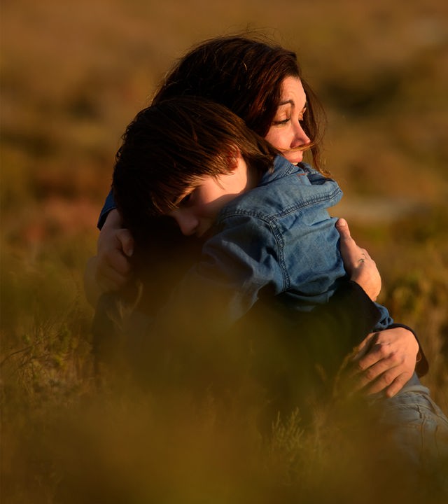 Sarah (Jenifer Bartoli) und Léo (Félix Bossuet) befinden sich auf einer Wiese. Sie umarmen sich.