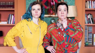Lin (Karin Hanczewski) und Gloria (Bärbel Schwarz) stehen vor dem Portrait der echten Therapeutin (Belinde Ruth Stieve).
