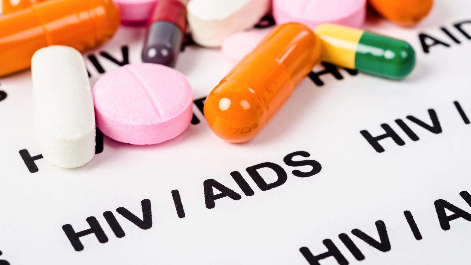 Pills on Hiv / aids paper background.