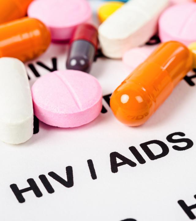 Pills on Hiv / aids paper background.