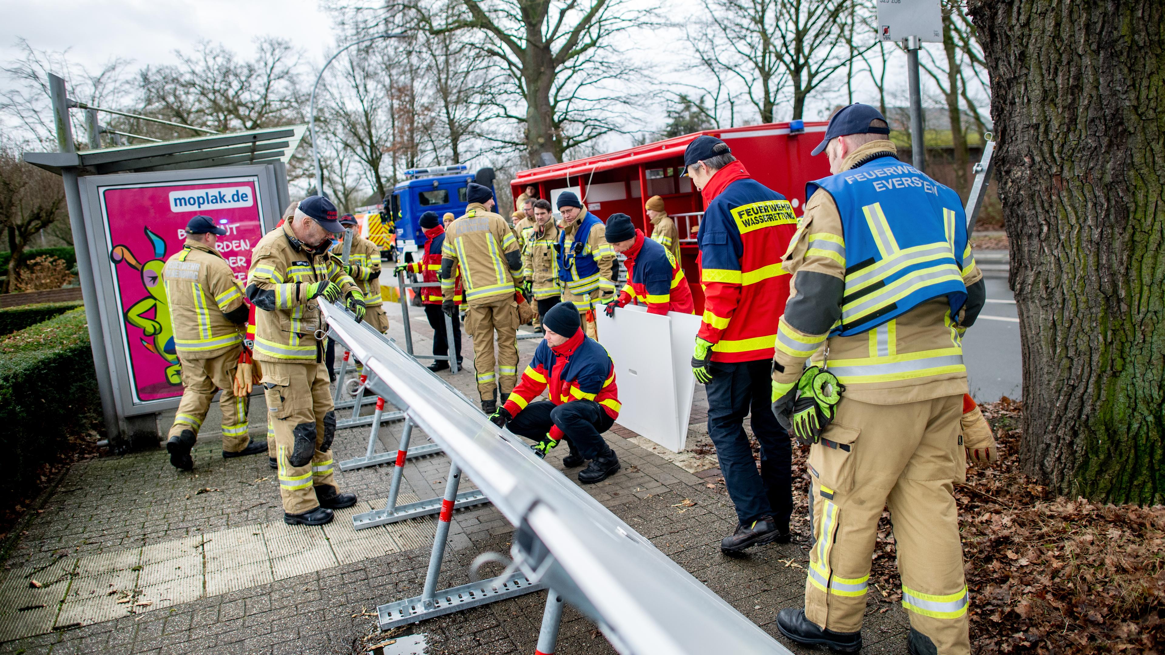 iedersachsen, Oldenburg: Einsatzkräfte der Feuerwehr stellen einen mobilen Deich im Stadtteil Bümmerstede auf.