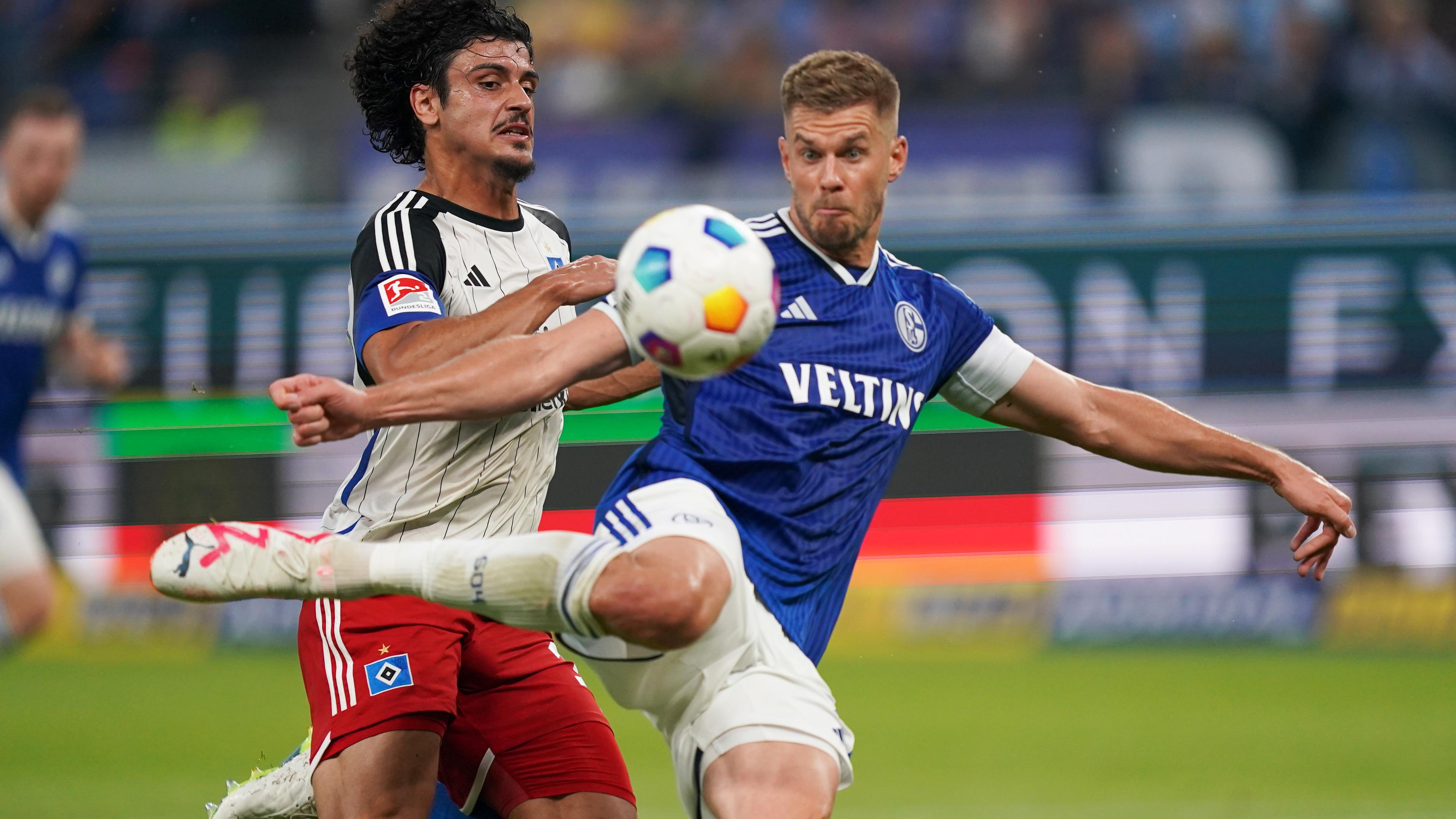 Hamburgs Guilherme Ramos (l) und Schalkes Simon Terodde kämpfen um den Ball.