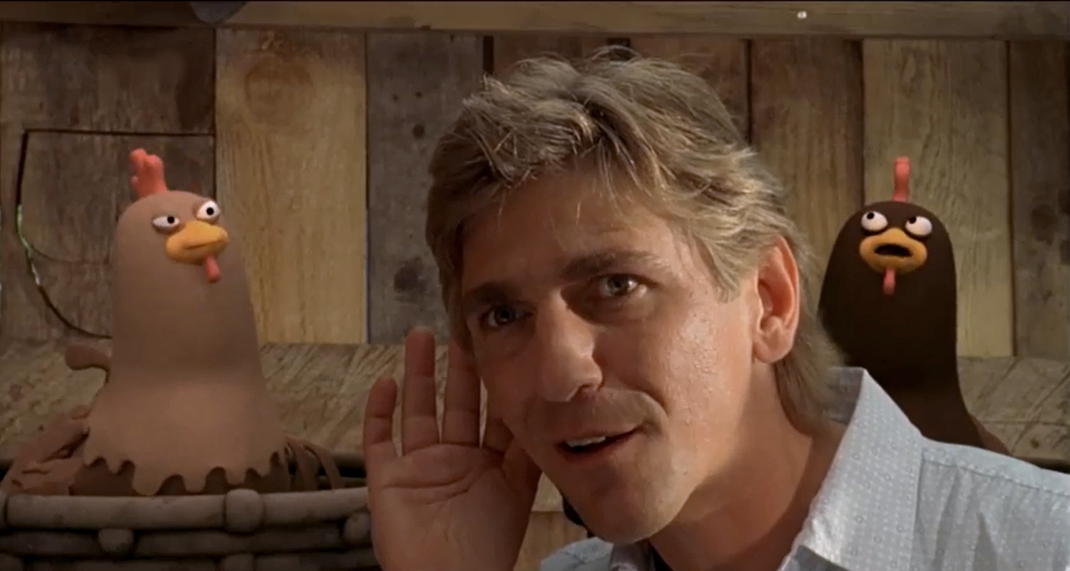 Ein singender Fritz Fuchs und ein Huhn mit Gitarre sind zu sehen.