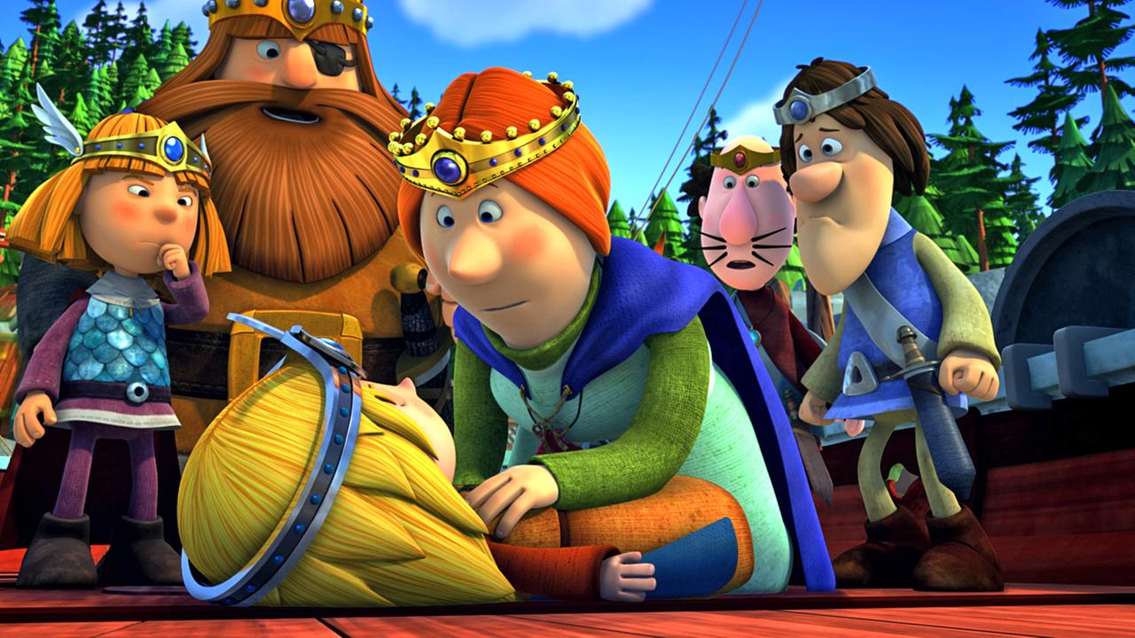 Die Wikinger spielen Theater. Im Vordergrund liegt Ylvi verkleidet als Gott der Freude auf dem Boden, Ylva beugt sich als Frigg über sie. Dahinter stehen die Wikinger. Wickie spielt Thor, den Gott des Donners. Rechts neben ihm steht Halvar als Odin. Gorm und Ulm sind ebenfalls verkleidet.