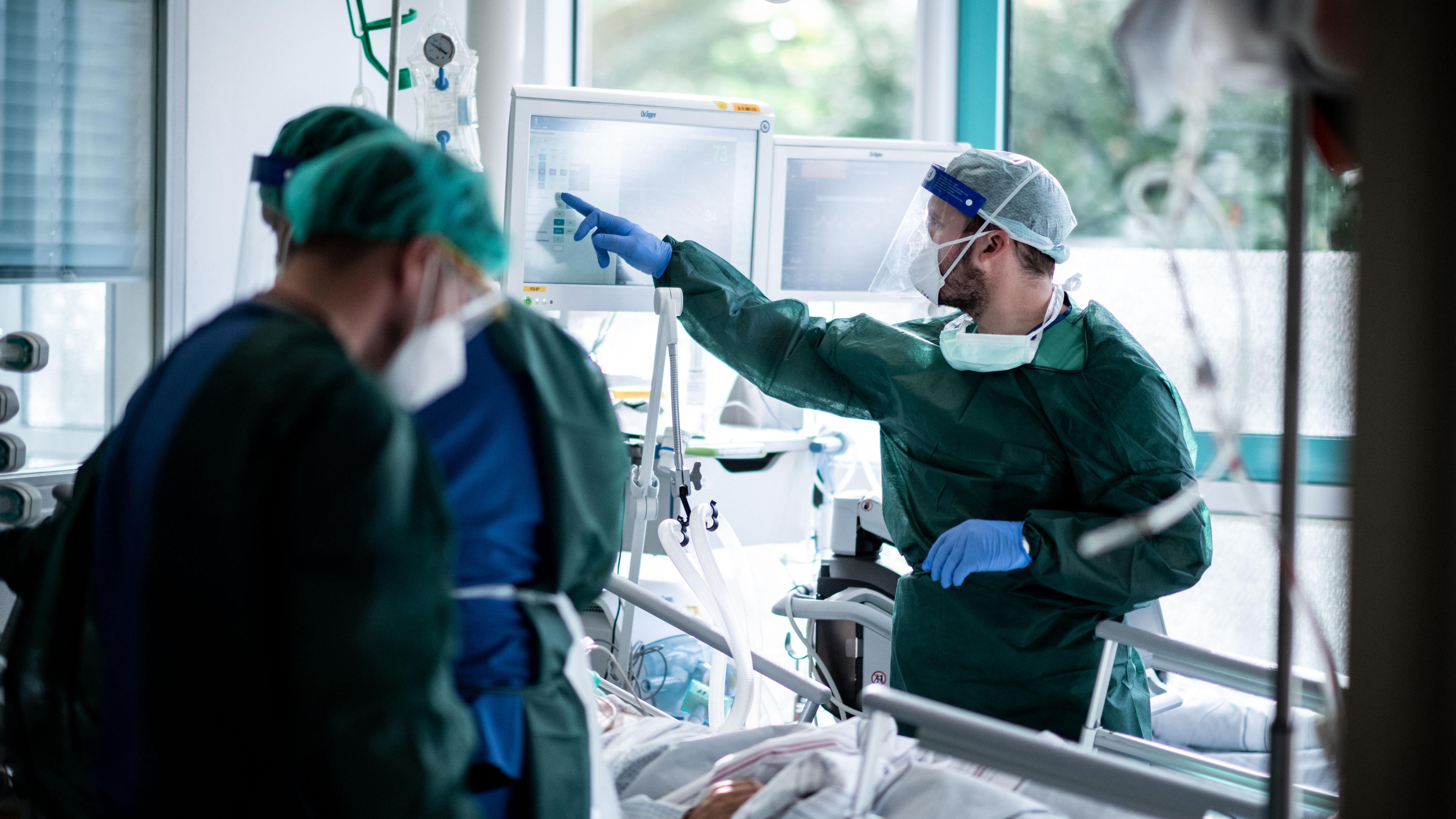 Mitarbeitende der Pflege in Schutzkleidung behandeln einen Patienten in Essen, Nordrhein-Westfalen am 28.10.2020