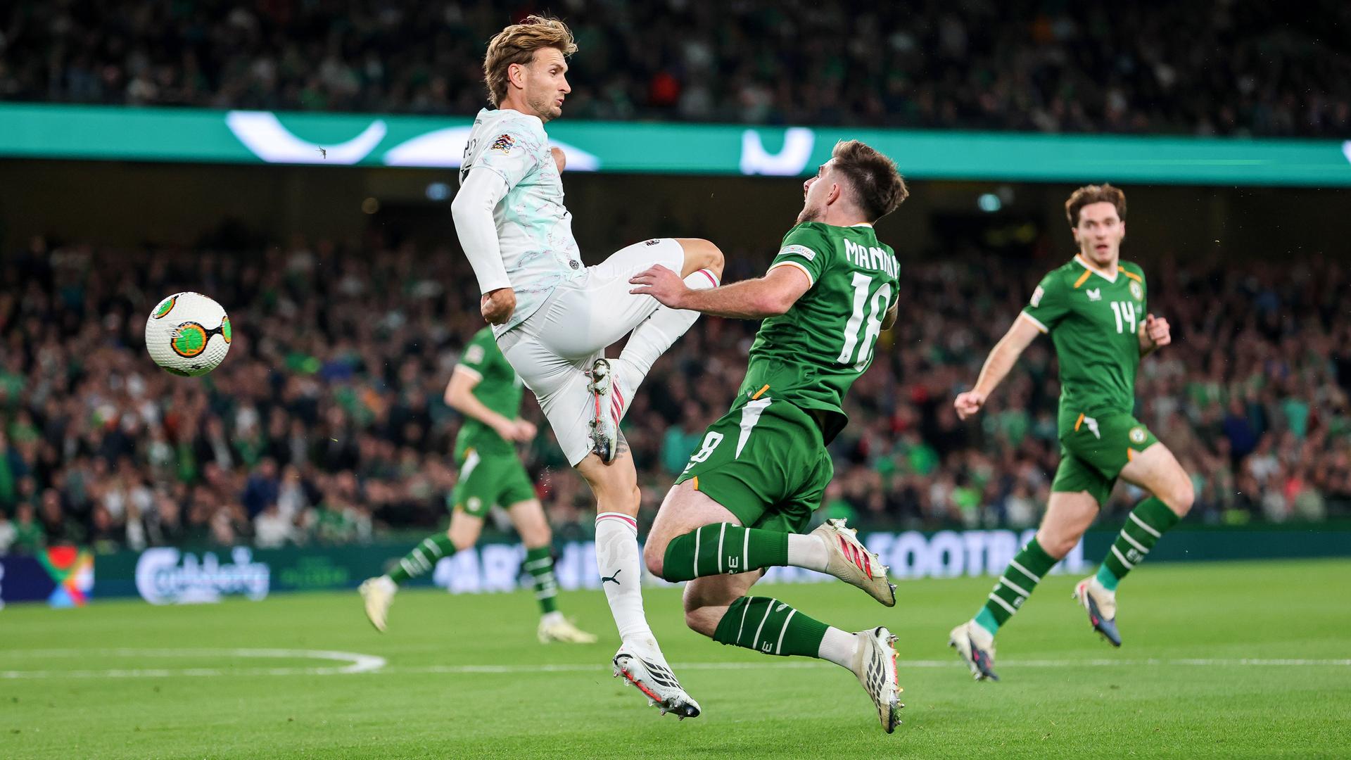 Der österreichische Nationalspieler Stefan Posch trifft im Zweikampf seinen irischen Gegenspieler Ryan Manning mit dem Knie.