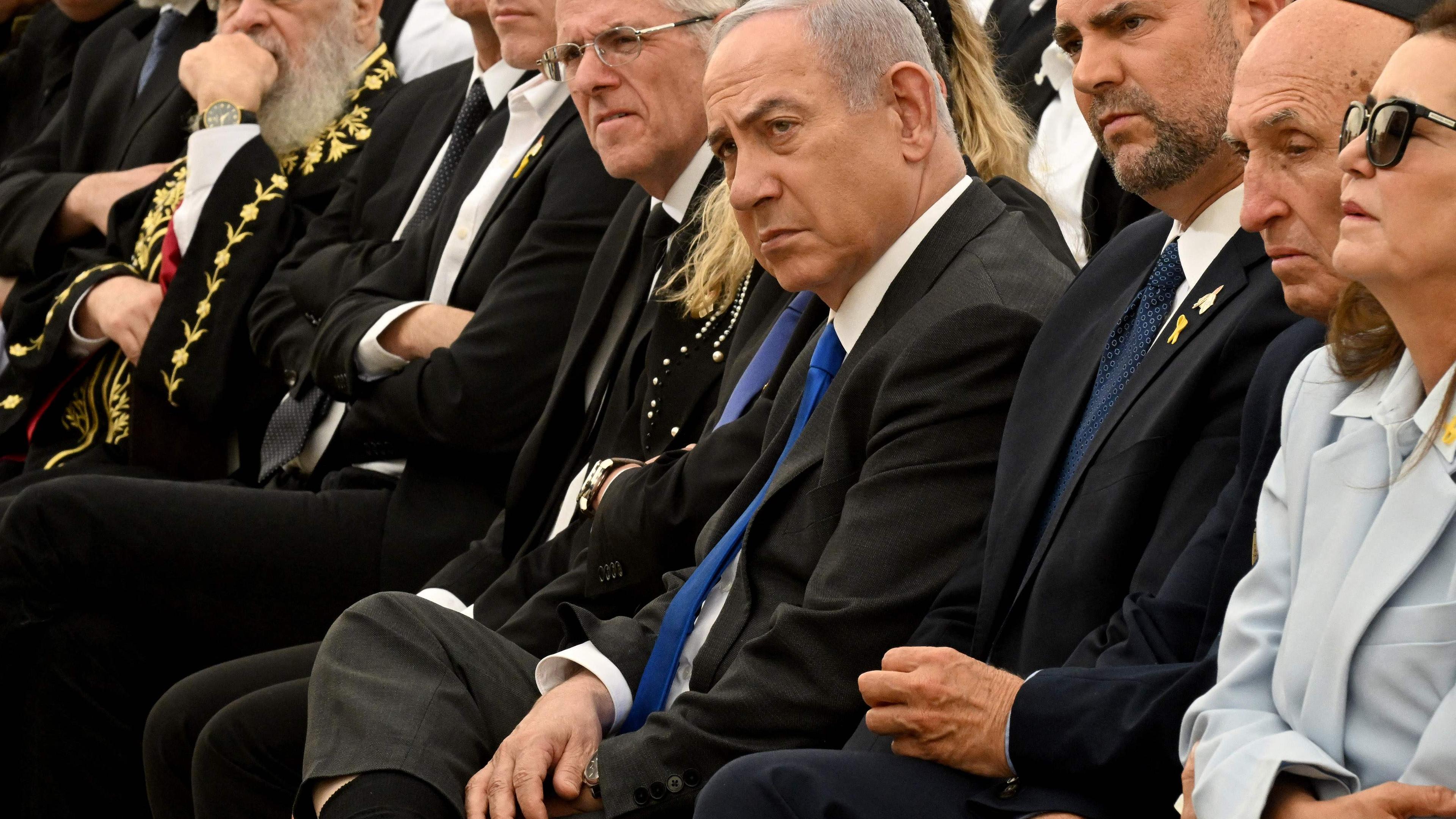 Israeli Prime Minister Benjamin Netanyahu (C) attends a ceremony on the eve of the Memorial Day for fallen soldiers