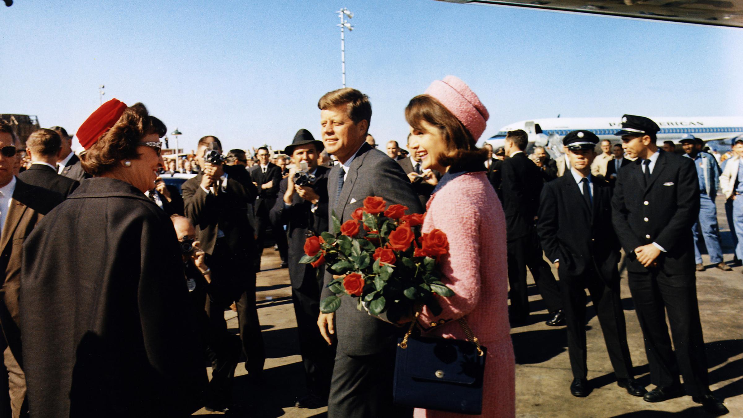 Mann und Frau laufen über das Rollfeld, im Hintergrund steht das Flugzeug.