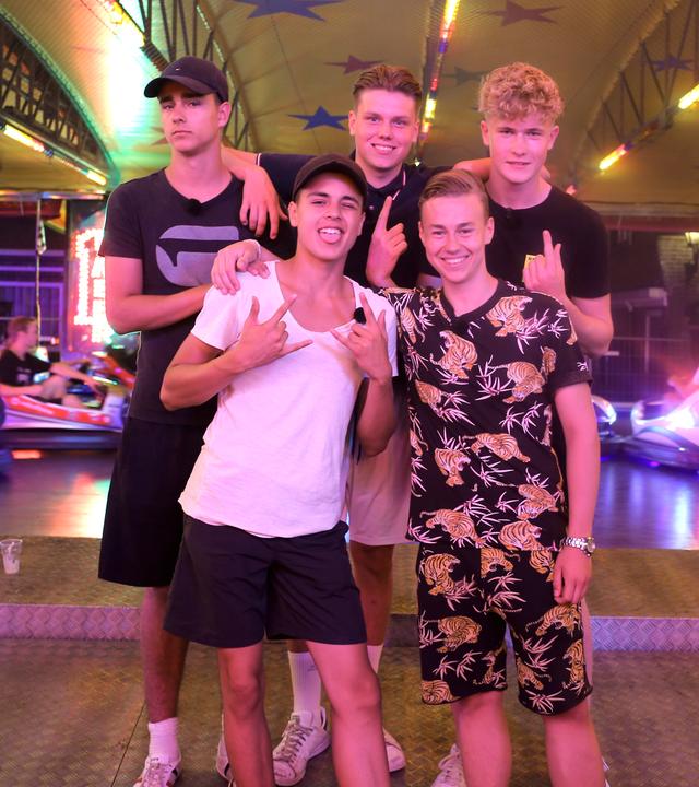 Luke, Ruben, Jeppe, Alex und Mark stehen vor einem Autoscooter