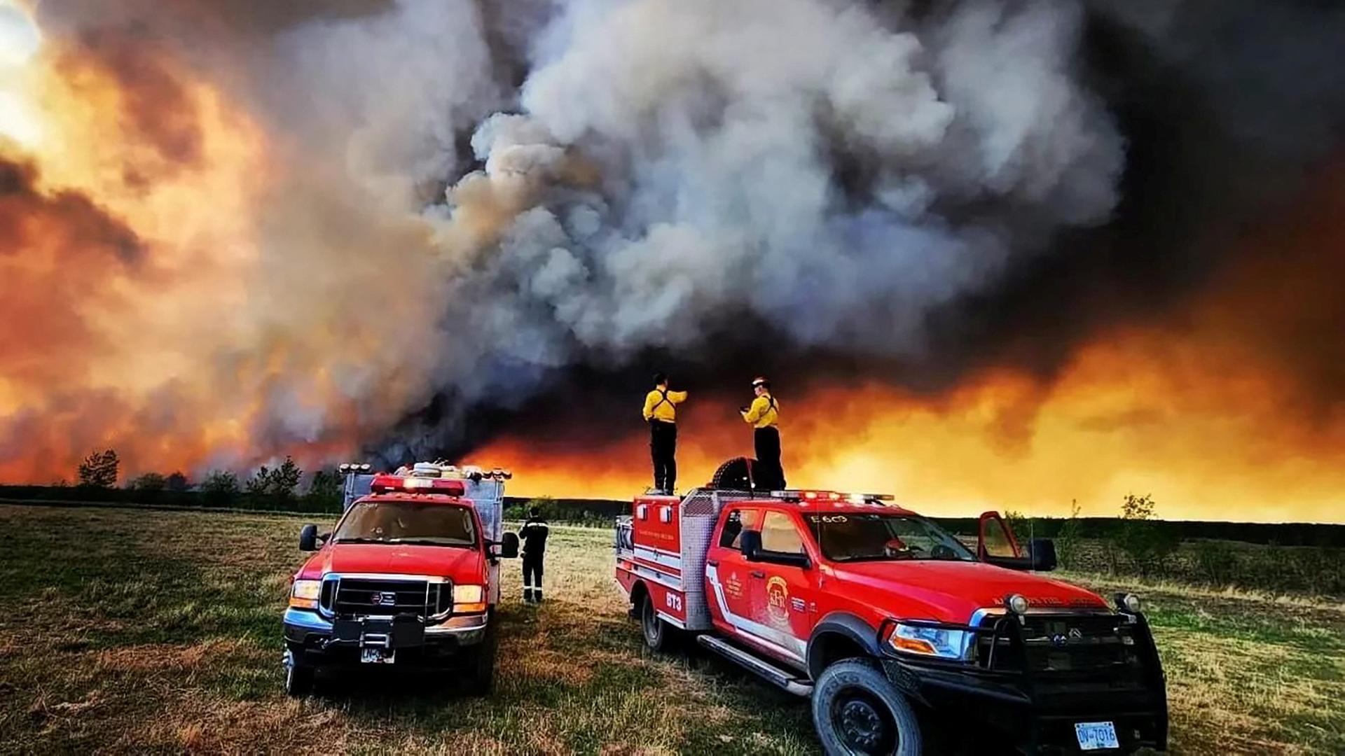 Kanada, Fort St. John: Feuerwehrautos am Rand des Waldbrandes