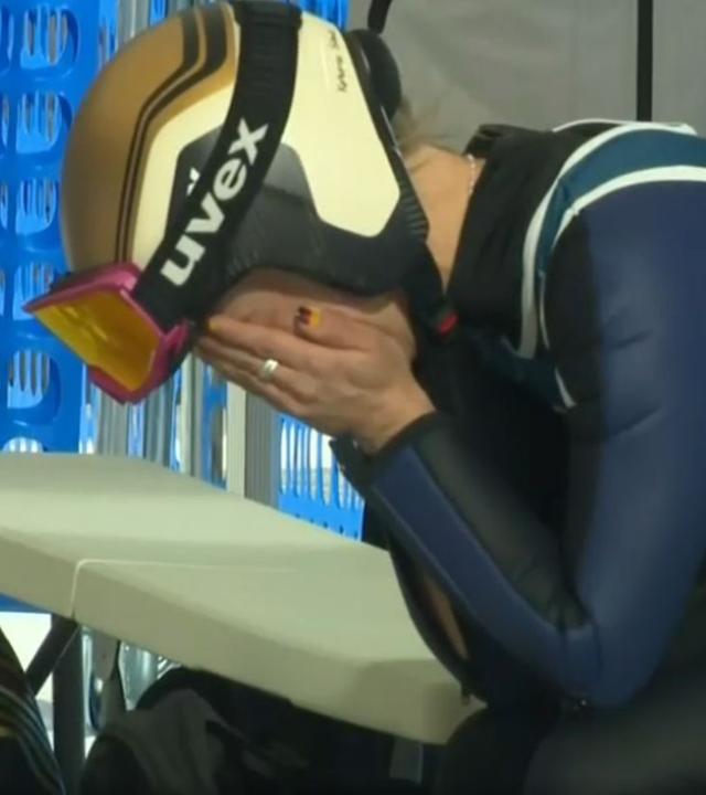 Skispringerin Katharina Schmid hält sich das Gesicht