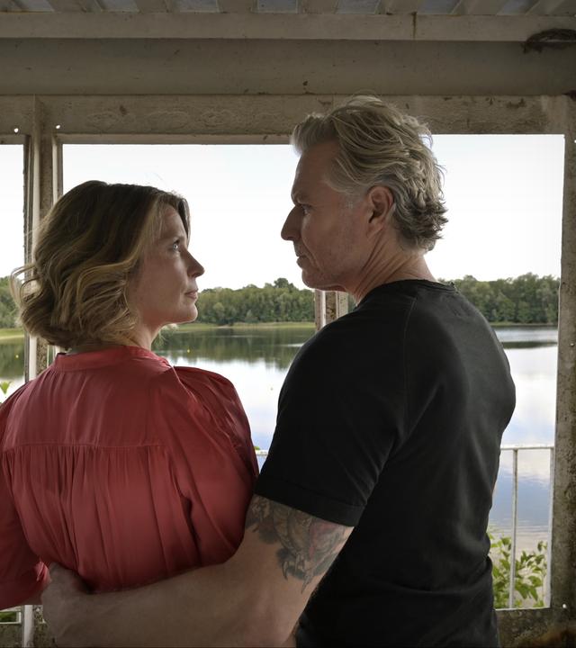 "Nächste Ausfahrt Glück - Katharinas Entscheidung": Katharina (Valerie Niehaus) und Juri (Dirk Borchardt) stehen nebeneinander auf einem Aussichtsturm und schauen sich an. Unter ihnen ist ein See mit begrüntem Ufer zu sehen.