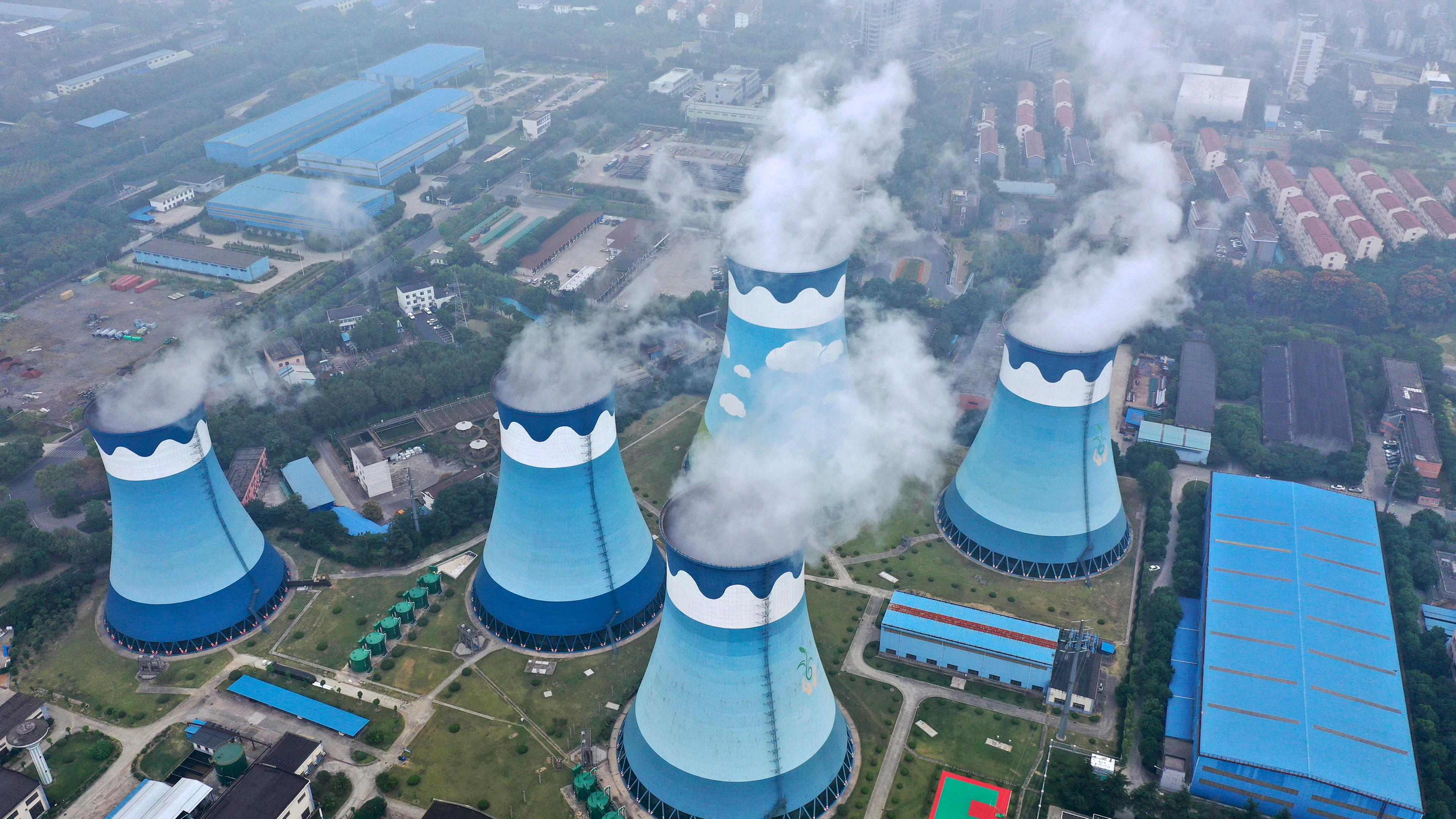 Dampfschwaden steigen aus den Kühltürmen eines Kohlekraftwerks in China