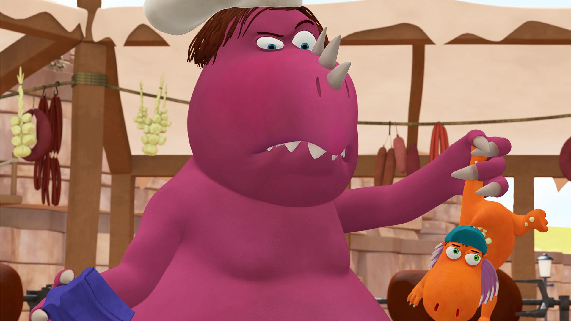 Chefkoch hält Kokosnuss an einem Bein über einen Kessel.