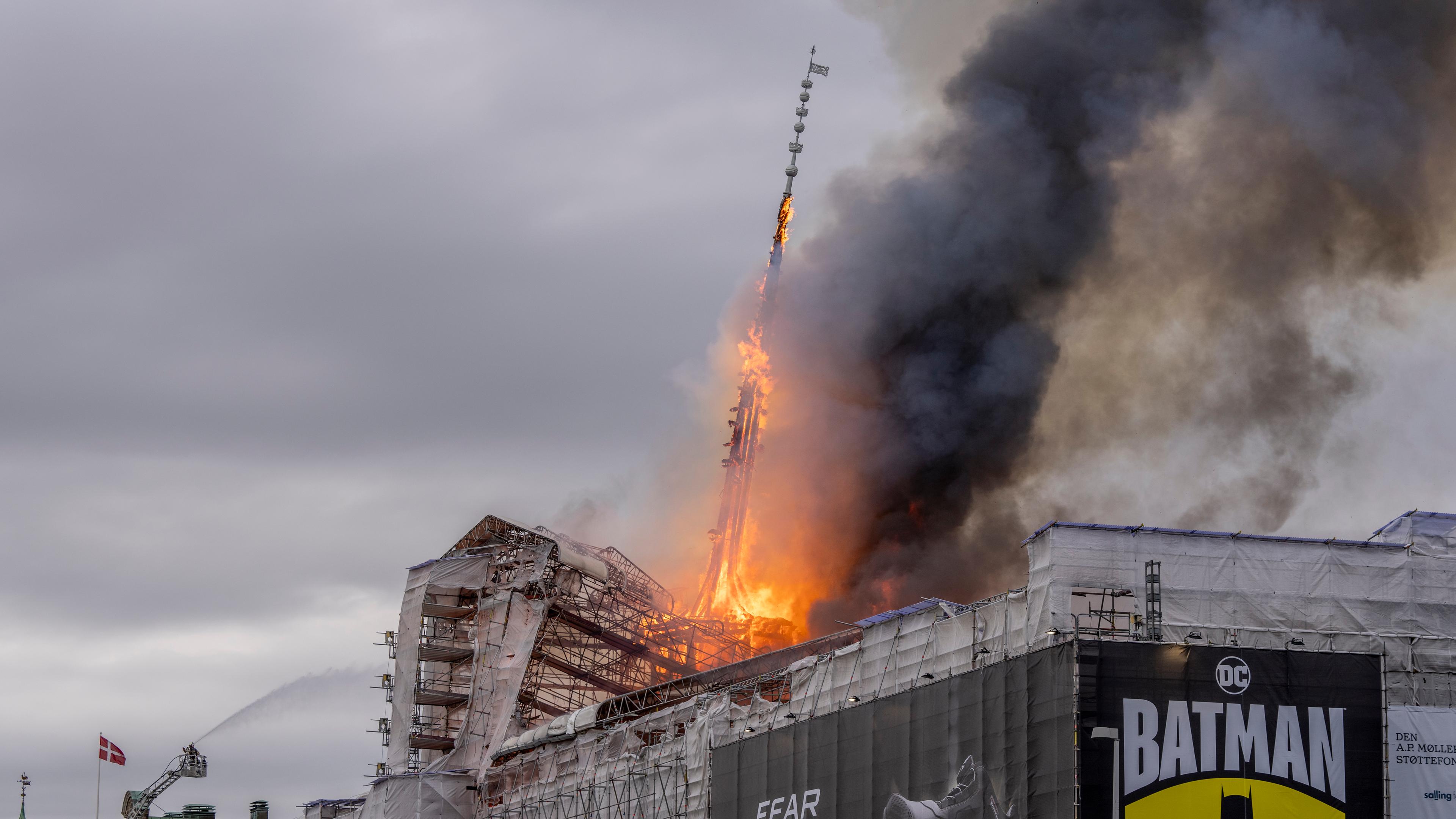 The dragon spire of the Stock Exchange is on fire on top the Boersen building in Copenhagen
